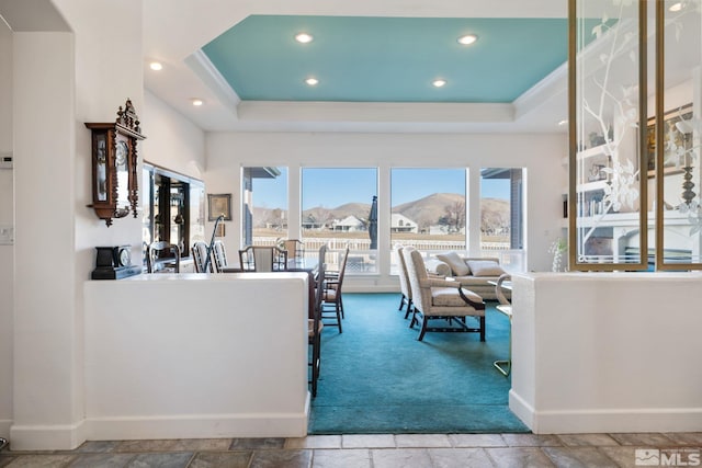 kitchen with a raised ceiling and a mountain view