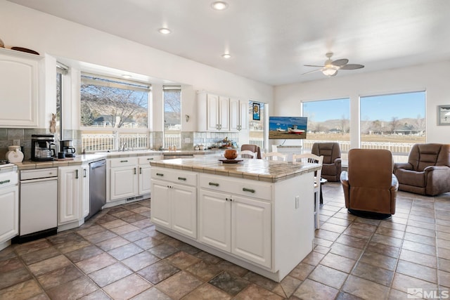 kitchen with ceiling fan, tile countertops, tasteful backsplash, and white cabinetry