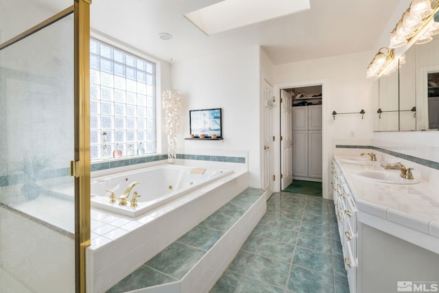 bathroom featuring tiled bath and vanity