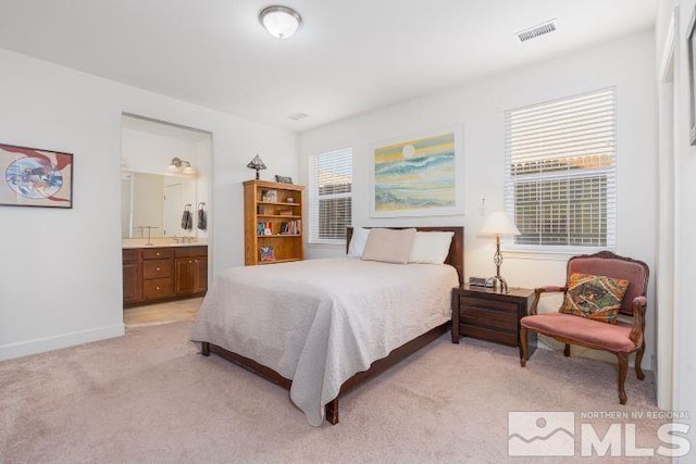 carpeted bedroom with ensuite bath