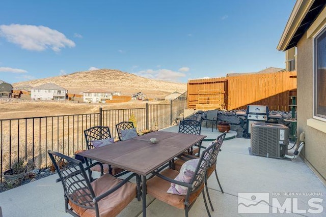 view of patio / terrace featuring a mountain view and central AC unit