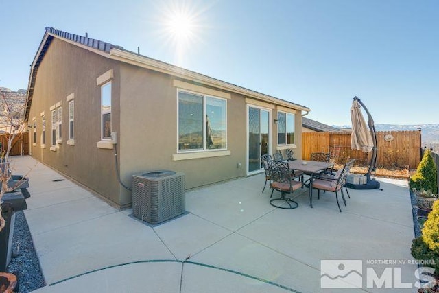 back of house with cooling unit and a patio