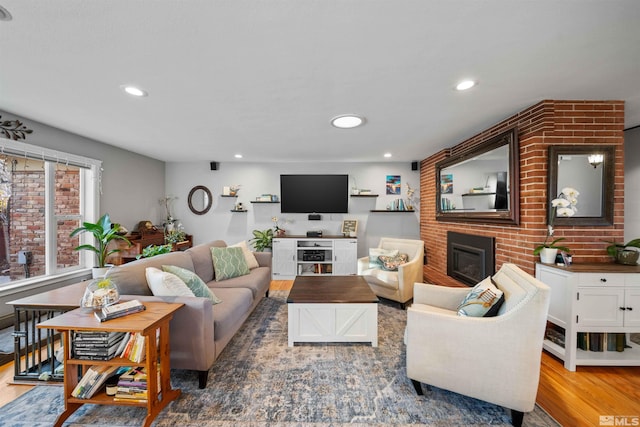 living room with wood-type flooring and a fireplace