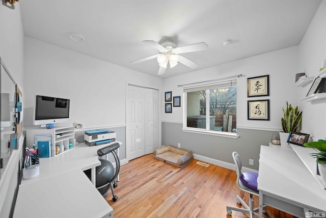 office space with light wood-type flooring and ceiling fan