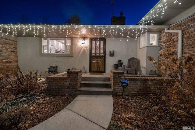 view of exterior entry at night