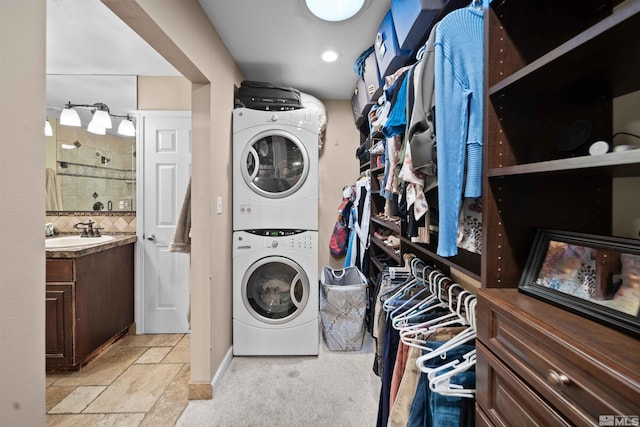 laundry room with stacked washing maching and dryer and sink