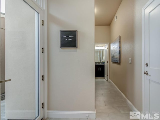 hall with light tile patterned flooring