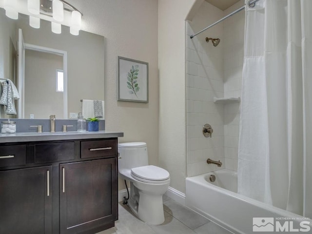 full bathroom featuring toilet, tile patterned floors, vanity, and shower / bath combo with shower curtain