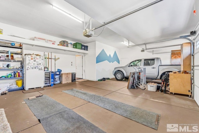 garage with a garage door opener and white fridge