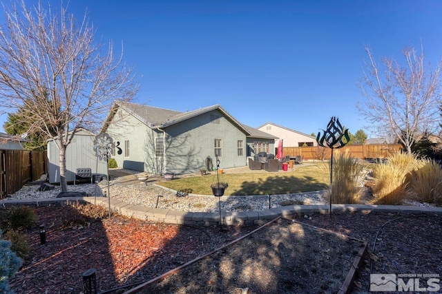 back of house featuring a storage unit, a patio area, and outdoor lounge area