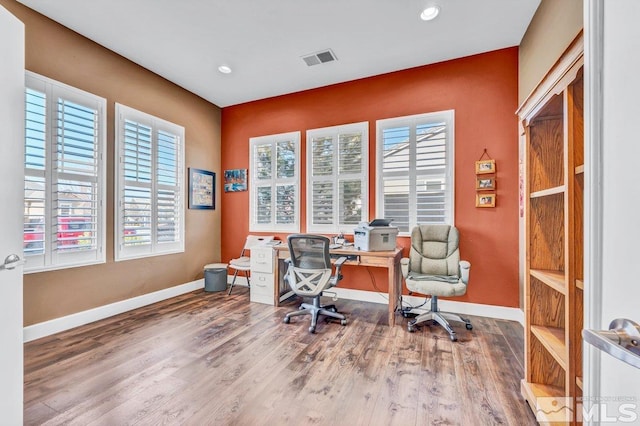 home office with hardwood / wood-style flooring