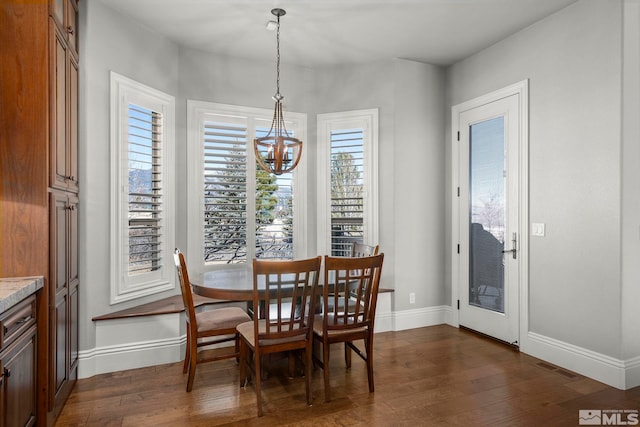 dining room featuring dark hardwood / wood-style flooring and a chandelier