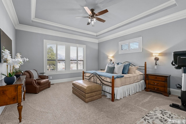 bedroom with ceiling fan, a tray ceiling, ornamental molding, and light carpet