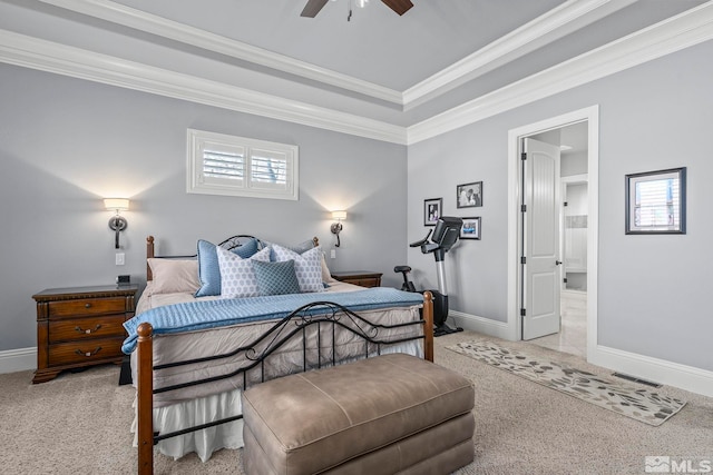 carpeted bedroom with ceiling fan, ensuite bath, and ornamental molding