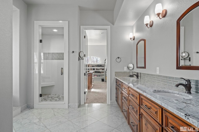 bathroom featuring vanity and a shower with door