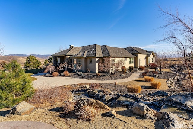 view of side of home with a mountain view