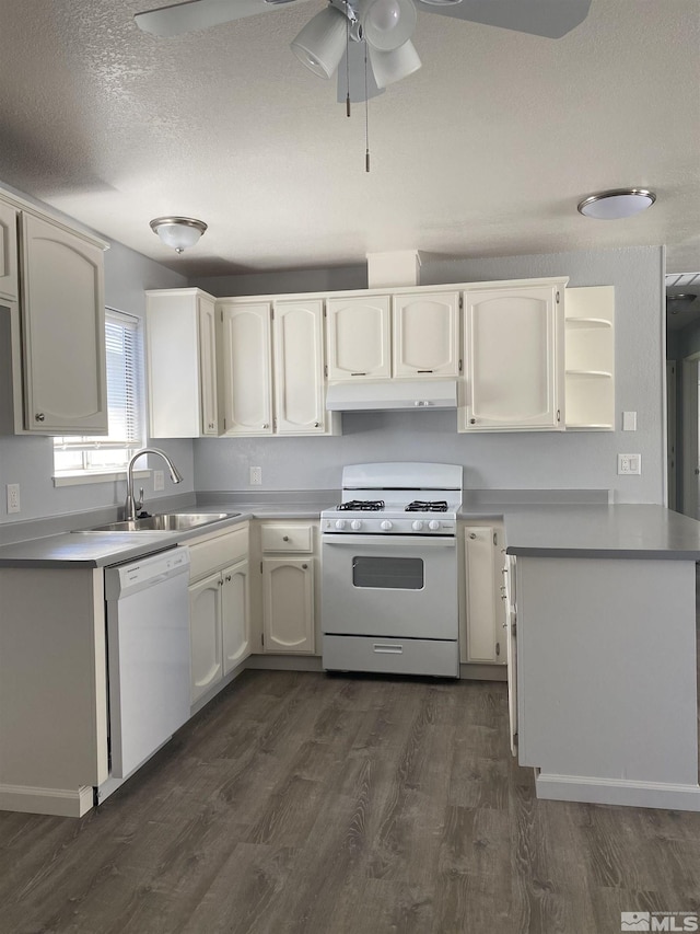 kitchen featuring dark hardwood / wood-style flooring, sink, white appliances, and white cabinetry