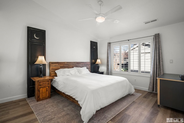 bedroom featuring ceiling fan, dark hardwood / wood-style flooring, and lofted ceiling