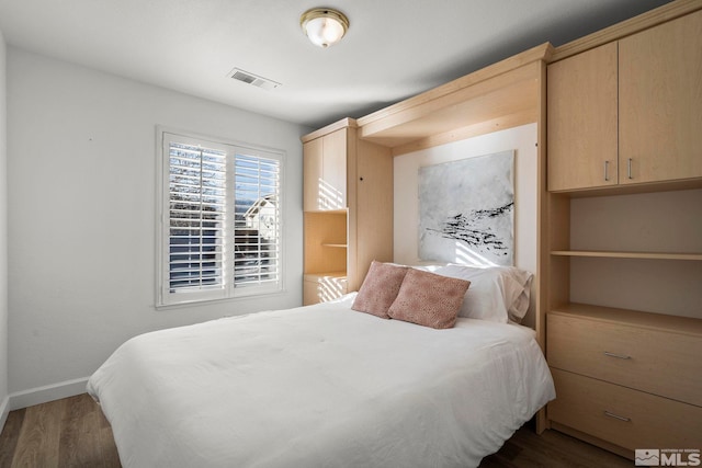 bedroom with wood-type flooring