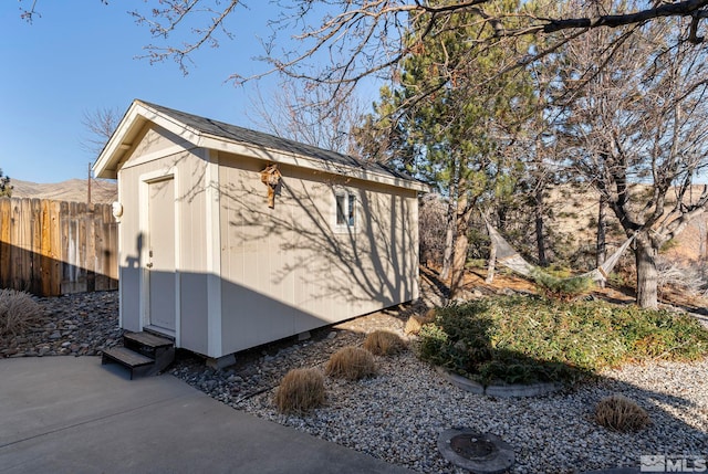 view of side of property featuring a storage shed