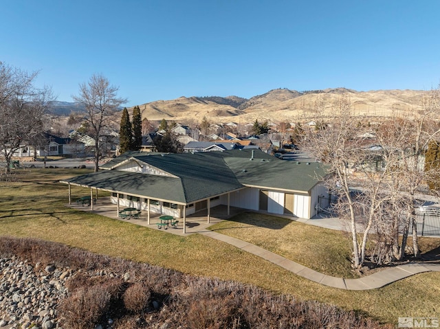 exterior space featuring a mountain view and a yard