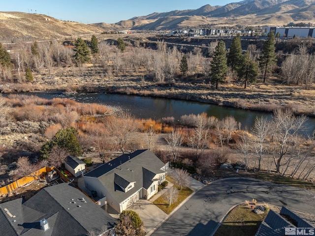 birds eye view of property with a water and mountain view