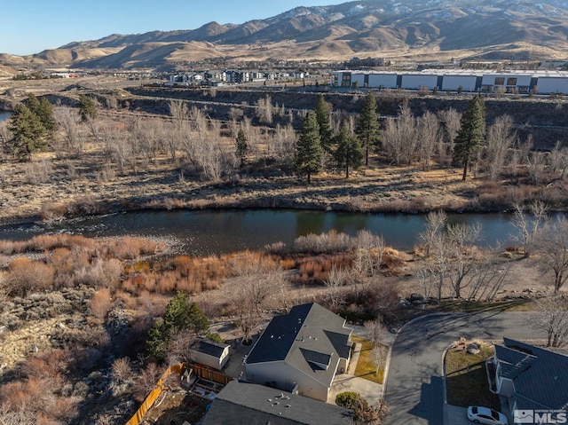 drone / aerial view with a water and mountain view