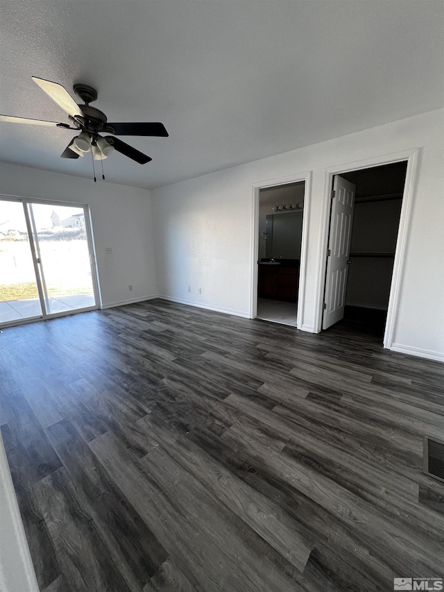 unfurnished room with a textured ceiling, ceiling fan, and dark hardwood / wood-style floors