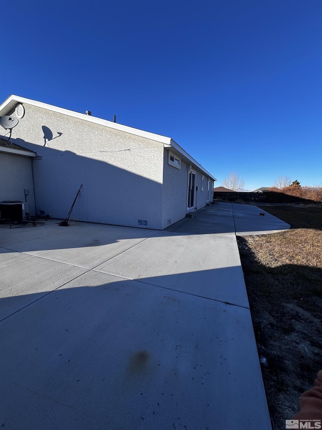 view of home's exterior with a patio area and cooling unit