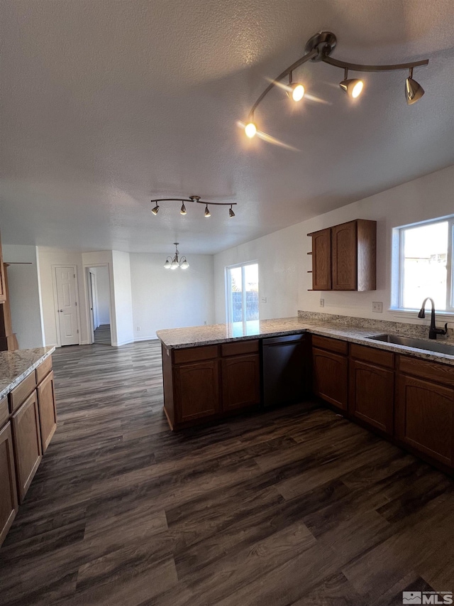 kitchen featuring a wealth of natural light, dishwasher, dark hardwood / wood-style flooring, and sink