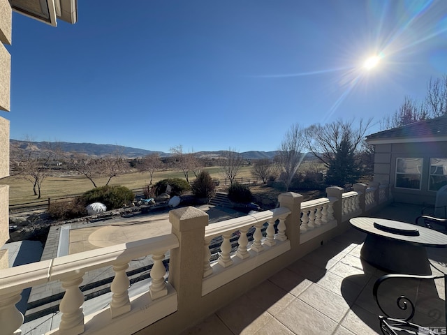 view of patio / terrace with a balcony and a mountain view