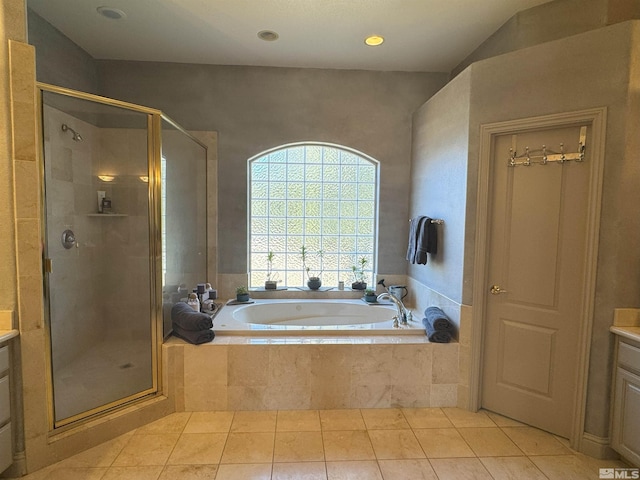 bathroom featuring plus walk in shower, tile patterned floors, and vanity