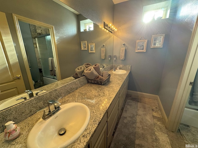 bathroom featuring vanity and shower / bath combination with glass door