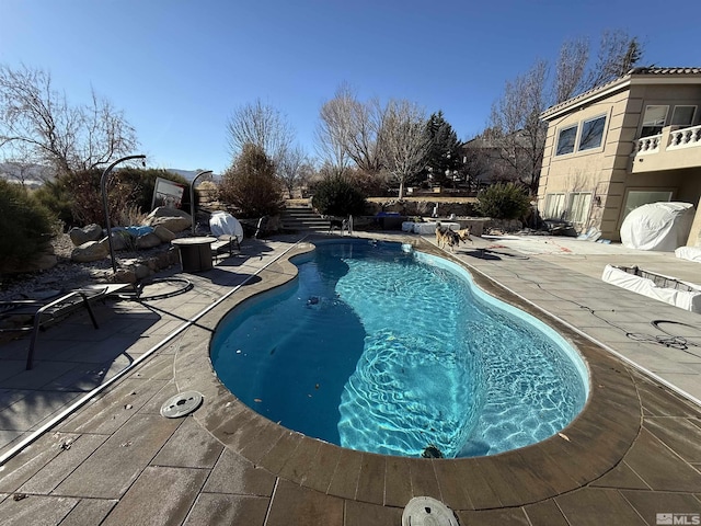 view of swimming pool featuring a patio