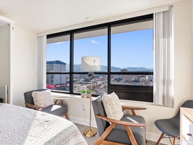 bedroom featuring a mountain view and hardwood / wood-style flooring