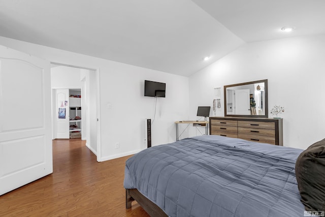 bedroom featuring lofted ceiling and dark hardwood / wood-style floors