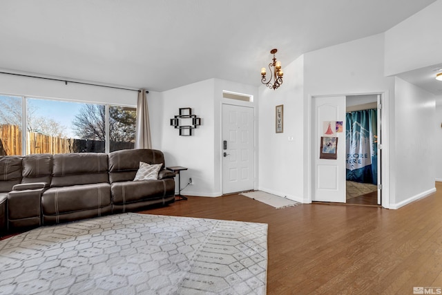 living room featuring dark hardwood / wood-style flooring and a notable chandelier