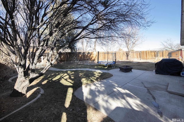 view of patio featuring a fire pit and a trampoline