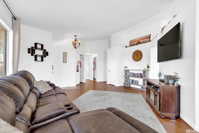 living room with a notable chandelier and hardwood / wood-style floors