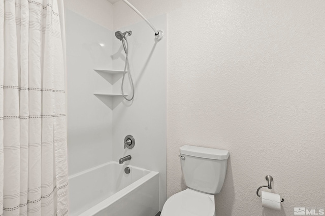 bathroom with toilet and shower / bath combo