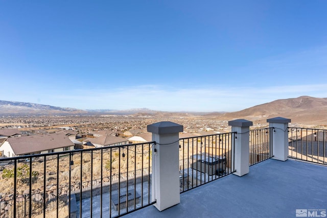 exterior space featuring a balcony and a mountain view