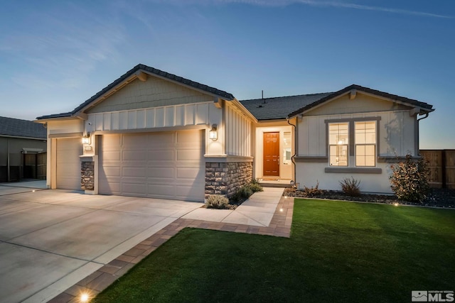 view of front of house featuring a garage and a lawn