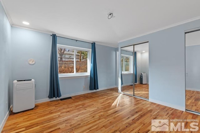 unfurnished bedroom featuring radiator, ornamental molding, and light hardwood / wood-style floors