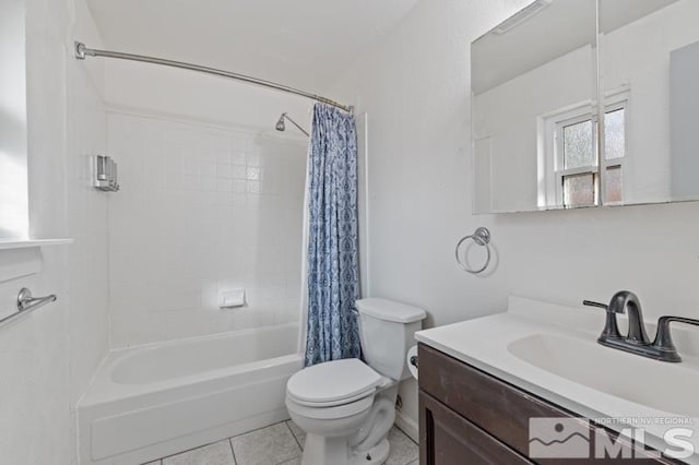 full bathroom featuring tile patterned floors, toilet, vanity, and shower / tub combo with curtain