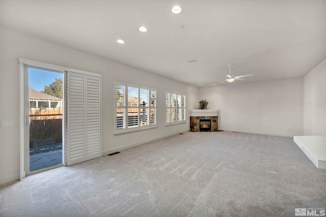 unfurnished living room featuring ceiling fan and light colored carpet