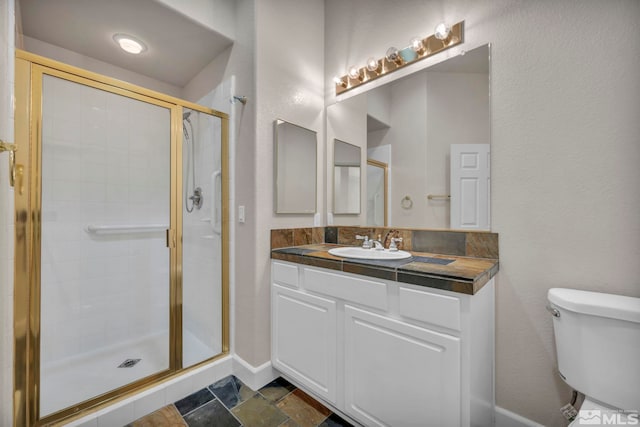 bathroom with toilet, walk in shower, and vanity