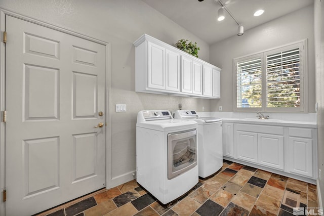 laundry room with cabinets, sink, and washing machine and clothes dryer