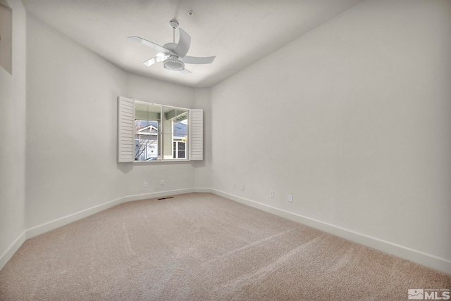 empty room with ceiling fan and carpet flooring