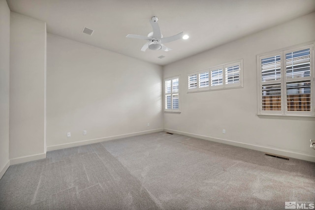 carpeted empty room featuring ceiling fan