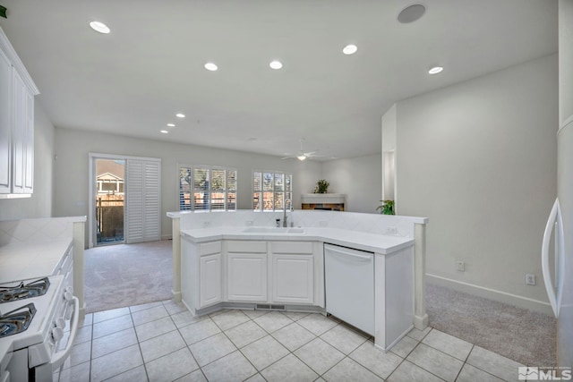 kitchen with light carpet, white cabinetry, ceiling fan, white appliances, and sink